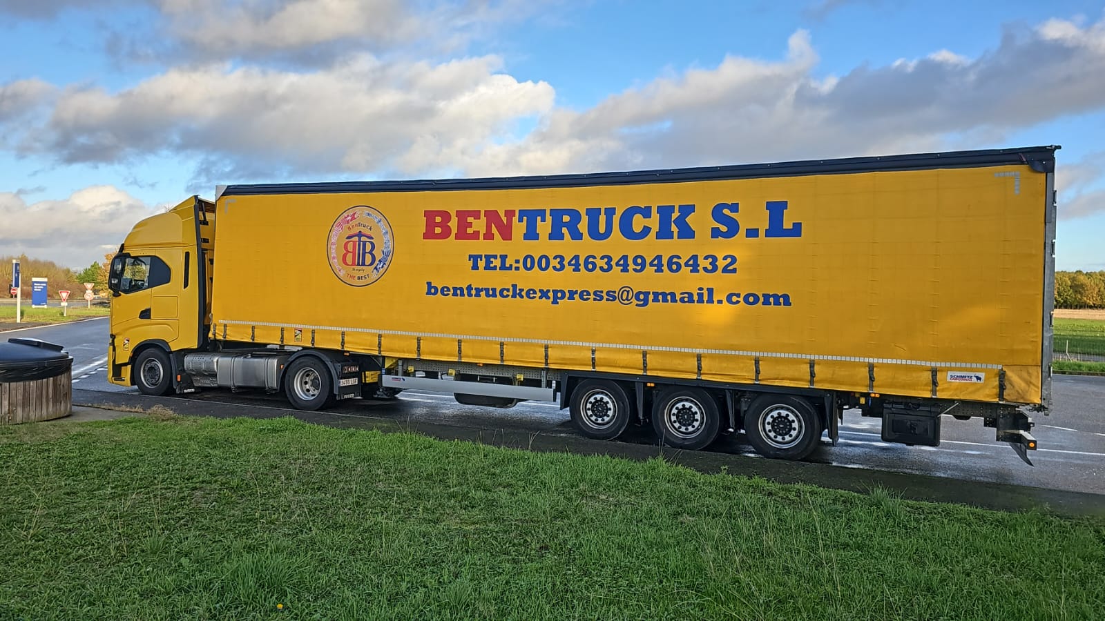 Photo of a truck transporting a tractor